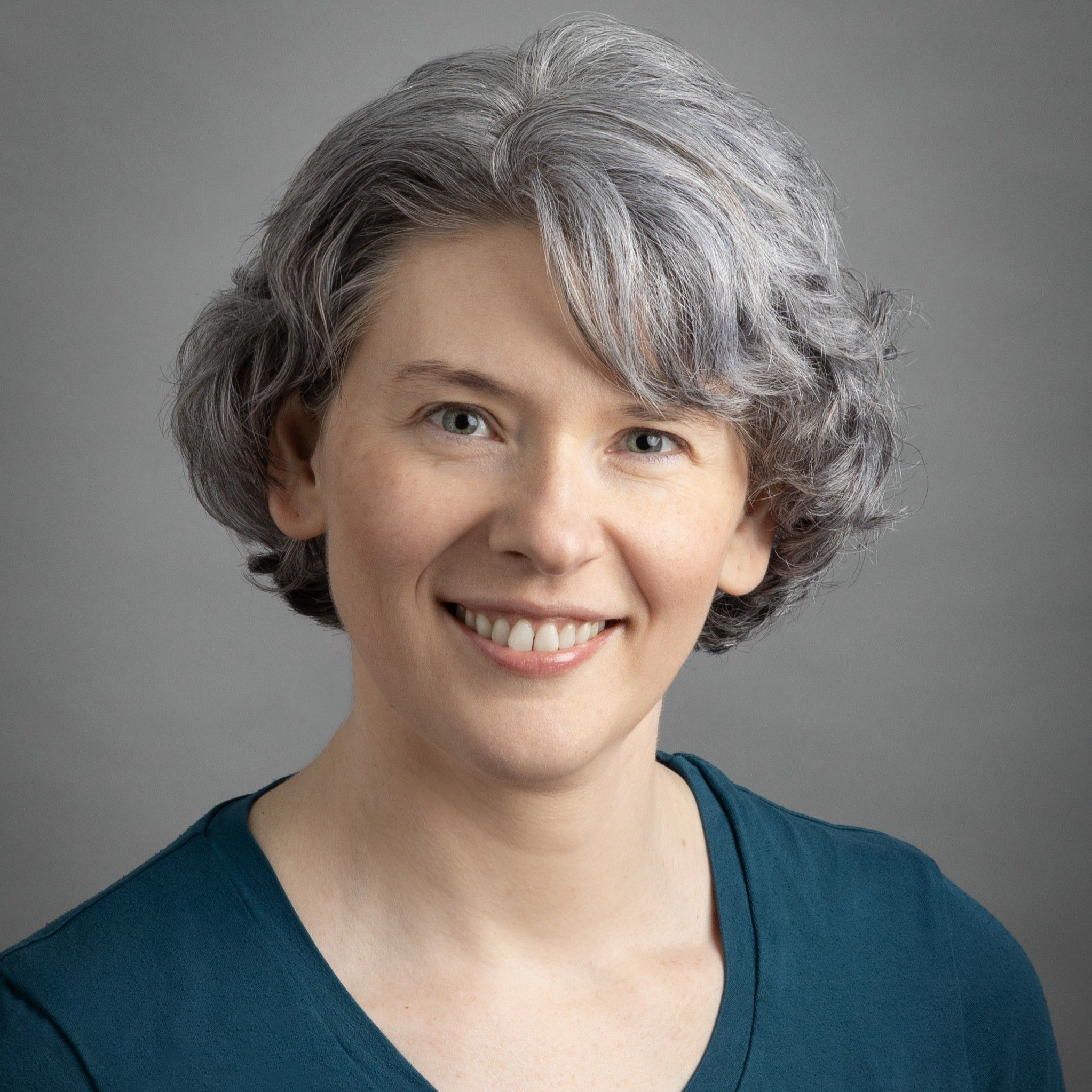 Julia Buchkina is a Caucasian woman with short blonde hair and blue eyes.