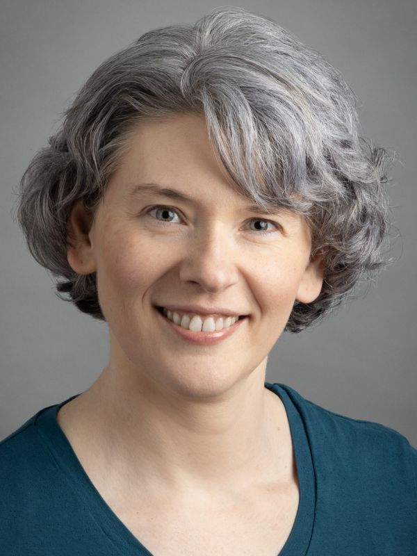 Julia Buchkina is a Caucasian woman with blonde hair and blue eyes. She is smiling brightly at the camera.